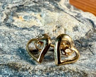 This lot features a pair of 14k gold "heart" earrings with a total approx. weight of .35 grams.

