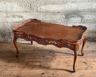 This lot features vintage French design carved mahogany coffee table that measures, 18” H x 38.5” W x 20.5” D.

