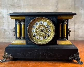 "Star", an antique mantel clock manufactured by W.M.L. Gilbert that measures, 10.75” H x 15.75” W x 7.25” D. Comes with key and pendulum in working condition.

