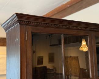 This lot features a large, solid wood cabinet with glass pane doors that measures, 84” H x 52” W x 13.5” D. This cabinet comes locked (no key) and without shelves.

