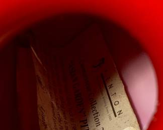 This lot features a Fenton Art Glass "Asian Garden" pitcher from the 2000 Connoisseur Collection. Limited edition 894/1850 and measures, 7.5” H x 5” W x 6” D. It features a hand-painted "Asian Garden" design on milk glass with a peach crest and a clear applied handle. The design was created by artist Robin Spindler and includes 22k gold highlights. 

