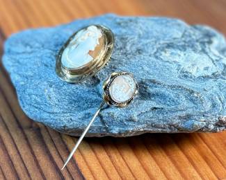 This lot features a pair of cameos – one is a brooch and the other is a stick pin. 

