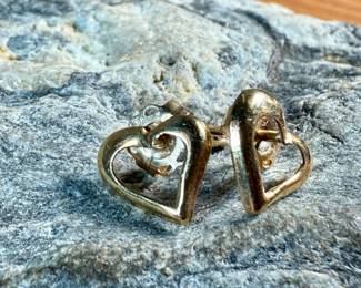 This lot features a pair of 14k gold "heart" earrings with a total approx. weight of .35 grams.

