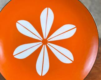 This lot features a vintage Cathrineholm orange Lotus plate, designed by Norwegian artist, Grete Prytz Kittelsen circa 1960s. This Lotus plate measures 10.25” H x 10.25” W.

