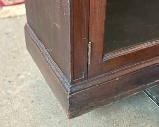 This lot features a large, solid wood cabinet with glass pane doors that measures, 84” H x 52” W x 13.5” D. This cabinet comes locked (no key) and without shelves.

