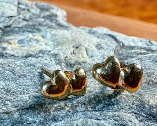 This lot features a pair of 14k gold "heart" earrings with a total approx. weight of .78 grams.

