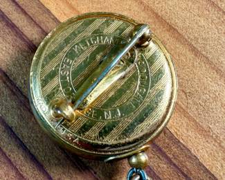 This lot features a vintage Ketcham & McDougall mechanical pencil disguised as a stick pin. It features a gold-filled body with a round, decorative top. 

