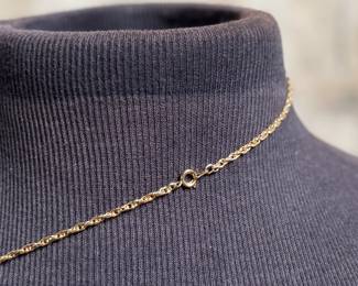 This lot features a gold-plated Walking Liberty pendant necklace that measures, 17”.

