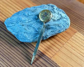 This lot features a vintage Ketcham & McDougall mechanical pencil disguised as a stick pin. It features a gold-filled body with a round, decorative top. 

