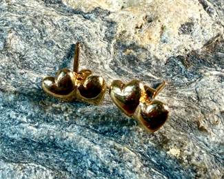 This lot features a pair of 14k gold "heart" earrings with a total approx. weight of .78 grams.

