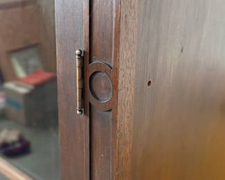 This lot features a large, solid wood cabinet with glass pane doors that measures, 84” H x 52” W x 13.5” D. This cabinet comes locked (no key) and without shelves.

