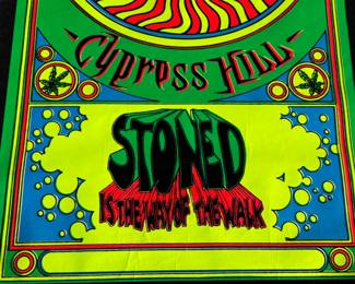 This lot features a vintage Cypress Hill "Stoned Is the Way of the Walk" black light poster. This poster features a skull with a cannabis afro smoking a joint and is designed with psychedelic colors and intended to glow under ultraviolet light. This poster measures, 34.5” H x 23” W.

