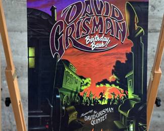 This lot features a 1996 David Grisman Quintet concert poster for a "Birthday Bash" event at The Warfield in San Francisco. The event featured the David Grisman Quintet with special guests including Vassar Clements, Peter Rowan, Herb Pederson, and John Kahn. This poster is an original print from the Bill Graham Presents series, identified by the code BGP-139 and the artwork was created by artist, Jim Phillips. This poster measures, 19” H x 13” W.

