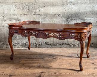 This lot features vintage French design carved mahogany coffee table that measures, 18” H x 38.5” W x 20.5” D.


