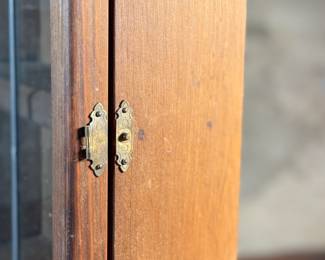 This lot features an antique spice cabinet with a stained glass door that measures, 22.5” H x 9.5” W x 4” D.

