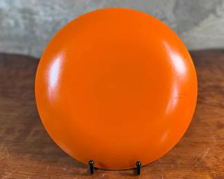 This lot features a vintage Cathrineholm orange Lotus plate, designed by Norwegian artist, Grete Prytz Kittelsen circa 1960s. This Lotus plate measures 10.25” H x 10.25” W.


