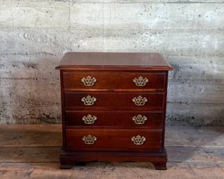 This lot features a tradition chippendale mahogany chest of drawers that measures, 23.5” H x 24” W x 14” D.

