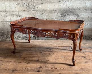 This lot features vintage French design carved mahogany coffee table that measures, 18” H x 38.5” W x 20.5” D.

