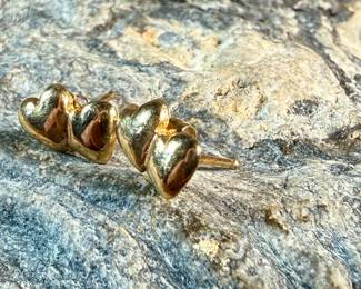 This lot features a pair of 14k gold "heart" earrings with a total approx. weight of .78 grams.

