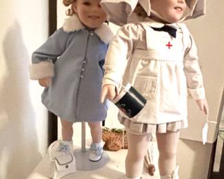 Two cute Shirley Temple dolls.   One Red Cross, the other is "Sunday's Best."