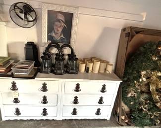 Garage has lots of frames, candles and light fixtures.