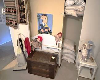 Vacuum is not for sale.  Antique trunk, white painted furniture and lots of clean pillows.