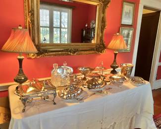 Silver serving dishes, gold leaf mirror