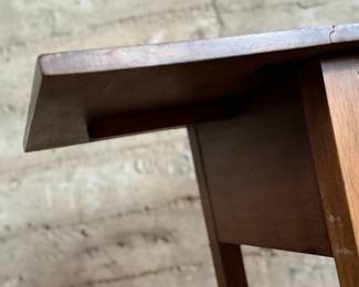 This lot features an antique drop-leaf side table with two dove-tailed drawers. This table measures (closed), 28.5” H x 19.5” W x 20.75” and each leaf adds an additional 11” of width. 

