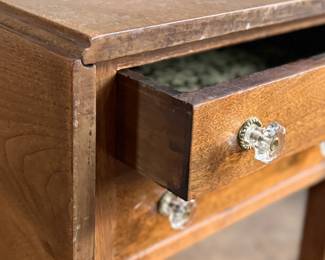 This lot features an antique drop-leaf side table with two dove-tailed drawers. This table measures (closed), 28.5” H x 19.5” W x 20.75” and each leaf adds an additional 11” of width. 

