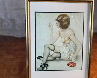 "Smoke Dreams", a hand-signed lithograph by listed artist, Alberto Vargas. Professionally framed and measures in frame, 12.75” H x 9.75” W. Vargas was a prominent 20th-century illustrator known for his sensual pin-up girl paintings that appeared in magazines like Esquire and Playboy. "Smoke Dreams" is one of the artist’s favorite works from the 1920s.

