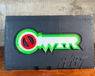 "Key, No War", an original mixed media sculpture by listed artist, Howard Hack. Included is also what appears to be the prototype for this series. Edition 5/50, hand-signed on the verso. Howard Edwin Hack (July 6, 1932 – June 11, 2015) was an American representational painter and graphic artist, with works in numerous museum collections. Known for an innovative approach to a variety of media, as well as use of traditional oil paints, Hack began working in the late 1940s.

