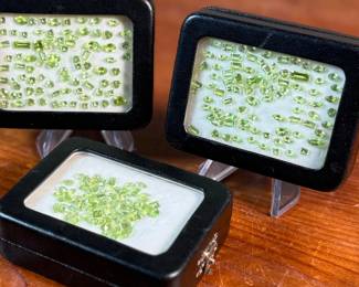 This lot features three (3) containers full of various sizes and cuts of peridot gemstones.

