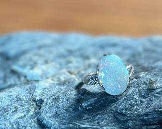 This lot features a stunning 14k gold ring with genuine diamonds and a large opal center stone. The ring has a mix of both yellow and white gold, comes in a size 5 with a total approx. weight of 4.71 grams.

