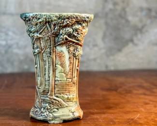 This lot features an antique Weller Pottery Forest vase. This design was created by Rudolph Lorber and produced between approximately 1915 and 1928. The vase measures, 8” H x 5.5” W x 3” D and comes in very good condition.


