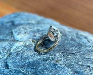 This lot features a stunning 14k gold ring with genuine diamonds and a large opal center stone. The ring has a mix of both yellow and white gold, comes in a size 5 with a total approx. weight of 4.71 grams.

