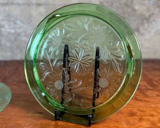 This lot features two pieces of antique uranium items including a cake plate and stand. Both glow under a black light and the platter measures, 10” H x 10” W.

