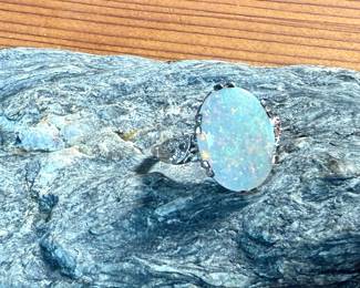 This lot features a stunning 14k gold ring with genuine diamonds and a large opal center stone. The ring has a mix of both yellow and white gold, comes in a size 5 with a total approx. weight of 4.71 grams.

