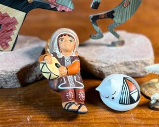This lot features a curated collection of Native American items including sculptures, Acoma potttery, and more.

