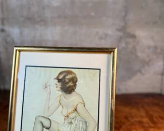 "Smoke Dreams", a hand-signed lithograph by listed artist, Alberto Vargas. Professionally framed and measures in frame, 12.75” H x 9.75” W. Vargas was a prominent 20th-century illustrator known for his sensual pin-up girl paintings that appeared in magazines like Esquire and Playboy. "Smoke Dreams" is one of the artist’s favorite works from the 1920s.

