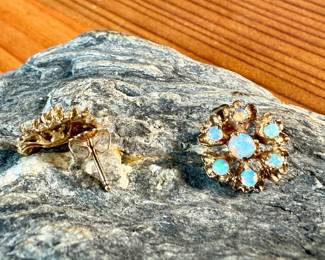 This lot features a pair of stunning 14k gold earrings, each containing seven (7) opals, circa 1940s. Total approx. weight of 2.58 grams.

