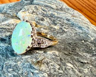 This lot features a stunning 14k gold ring with genuine diamonds and a large opal center stone. The ring has a mix of both yellow and white gold, comes in a size 5 with a total approx. weight of 4.71 grams.

