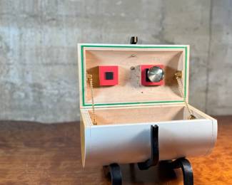 This lot features an original work of art by listed artist, Garry Knox Bennett. This piece is a uniquely designed humidor, signed by Bennett underneath circa 1997. This piece measures, 10” H x 11” W x 9” D. Born in Alameda, California, Garry Knox Bennett is a self-taught studio furniture maker who uses traditional fine woodworking techniques for both synthetic and natural materials. He attended the California College of Arts and Crafts in Oakland from 1959 to 1962 and then worked as a metal sculptor.

