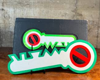 "Key, No War", an original mixed media sculpture by listed artist, Howard Hack. Included is also what appears to be the prototype for this series. Edition 5/50, hand-signed on the verso. Howard Edwin Hack (July 6, 1932 – June 11, 2015) was an American representational painter and graphic artist, with works in numerous museum collections. Known for an innovative approach to a variety of media, as well as use of traditional oil paints, Hack began working in the late 1940s.

