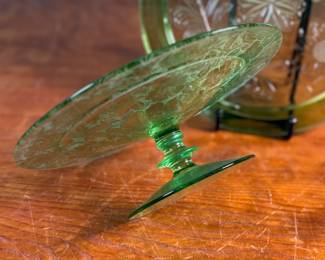 This lot features two pieces of antique uranium items including a cake plate and stand. Both glow under a black light and the platter measures, 10” H x 10” W.

