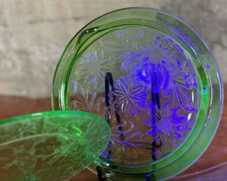 This lot features two pieces of antique uranium items including a cake plate and stand. Both glow under a black light and the platter measures, 10” H x 10” W.

