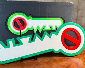 "Key, No War", an original mixed media sculpture by listed artist, Howard Hack. Included is also what appears to be the prototype for this series. Edition 5/50, hand-signed on the verso. Howard Edwin Hack (July 6, 1932 – June 11, 2015) was an American representational painter and graphic artist, with works in numerous museum collections. Known for an innovative approach to a variety of media, as well as use of traditional oil paints, Hack began working in the late 1940s.

