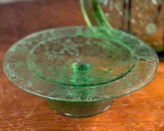 This lot features two pieces of antique uranium items including a cake plate and stand. Both glow under a black light and the platter measures, 10” H x 10” W.


