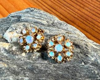 This lot features a pair of stunning 14k gold earrings, each containing seven (7) opals, circa 1940s. Total approx. weight of 2.58 grams.

