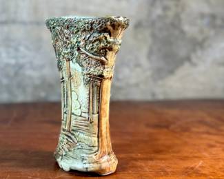 This lot features an antique Weller Pottery Forest vase. This design was created by Rudolph Lorber and produced between approximately 1915 and 1928. The vase measures, 8” H x 5.5” W x 3” D and comes in very good condition.

