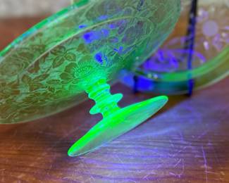 This lot features two pieces of antique uranium items including a cake plate and stand. Both glow under a black light and the platter measures, 10” H x 10” W.

